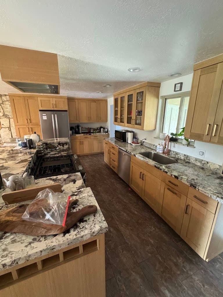 Spotless kitchen with clean granite countertops and organized appliances