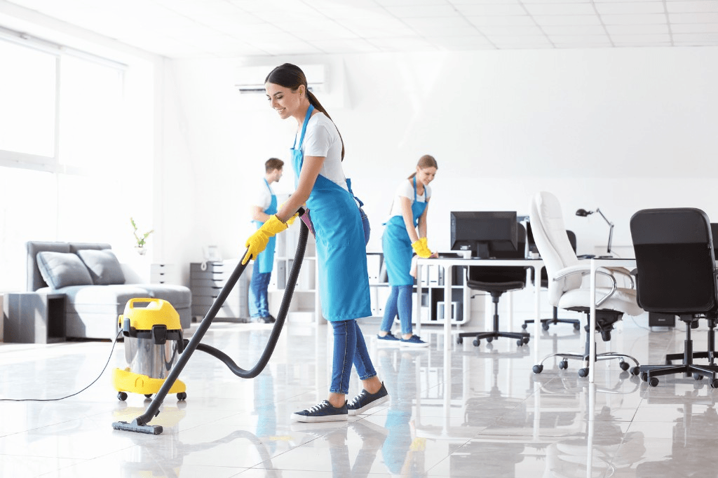 Cleaner vacuuming a commercial office space